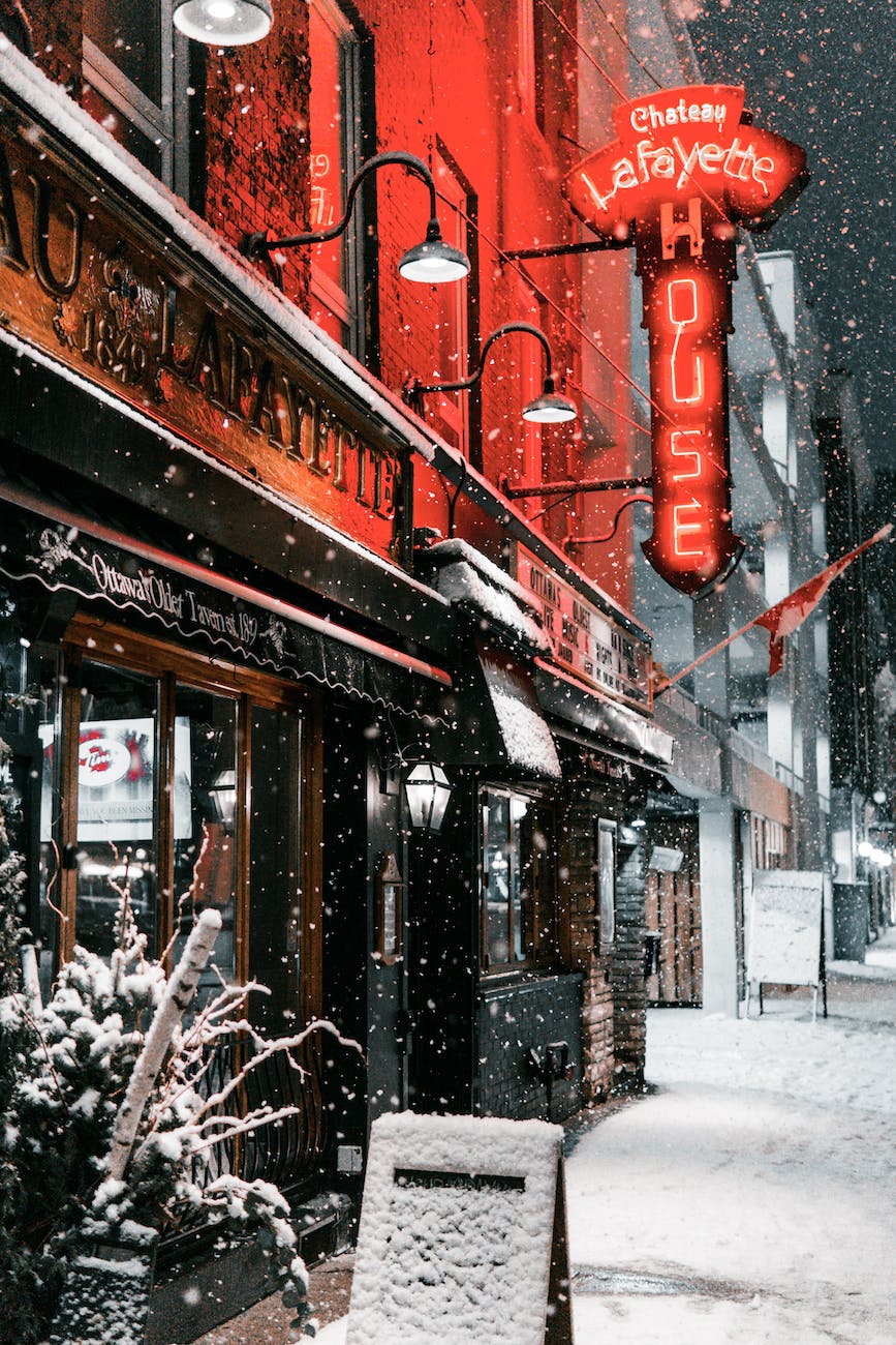 snow covered signage outside a tavern