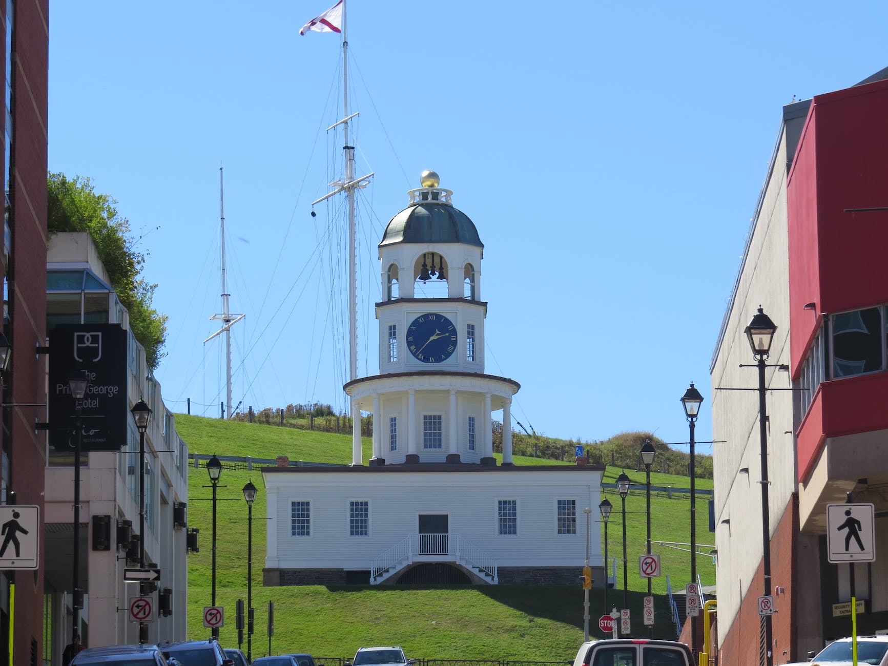 clock tower beside a flag pole