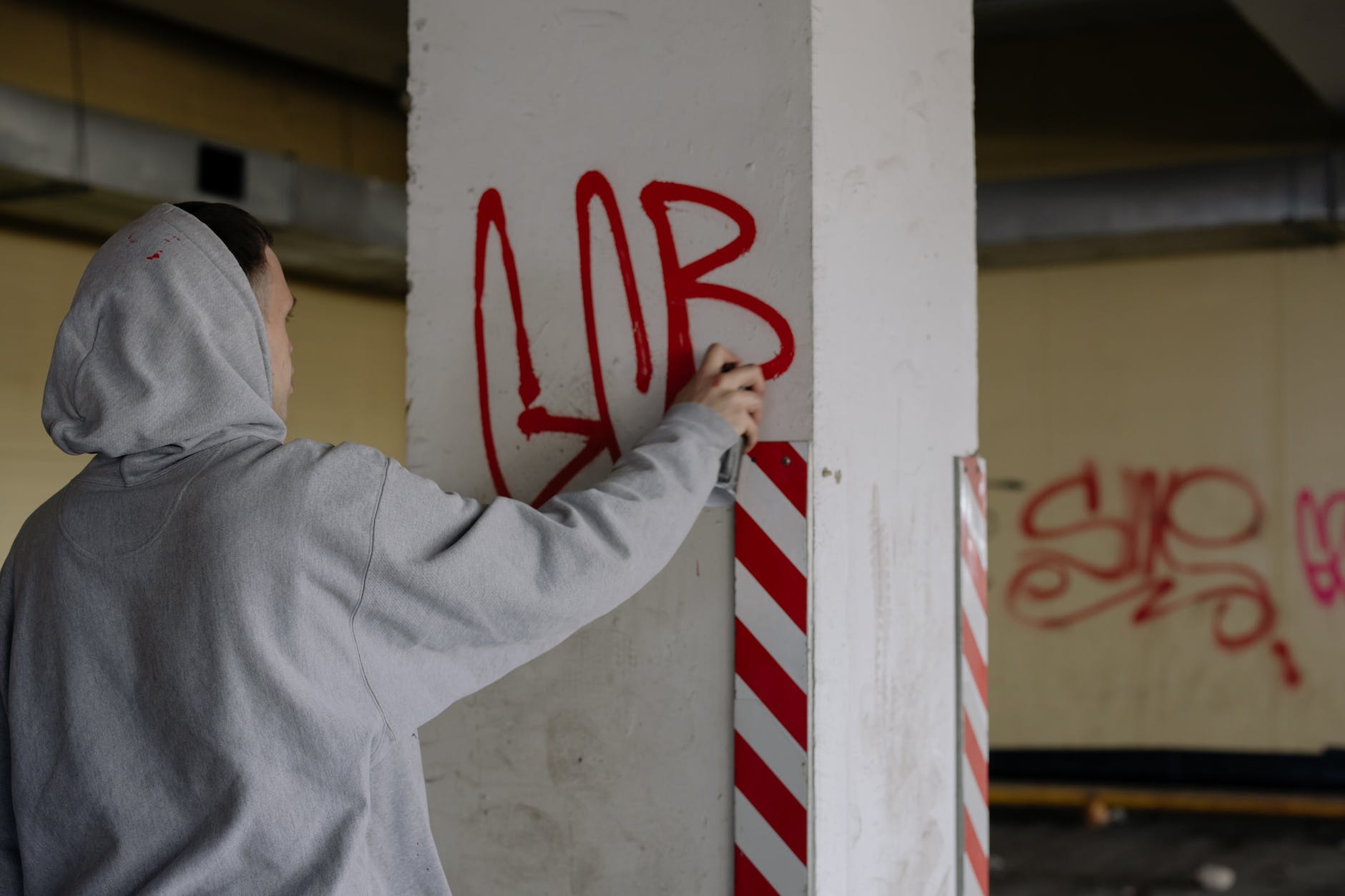 a person doing vandalism on a concrete wall